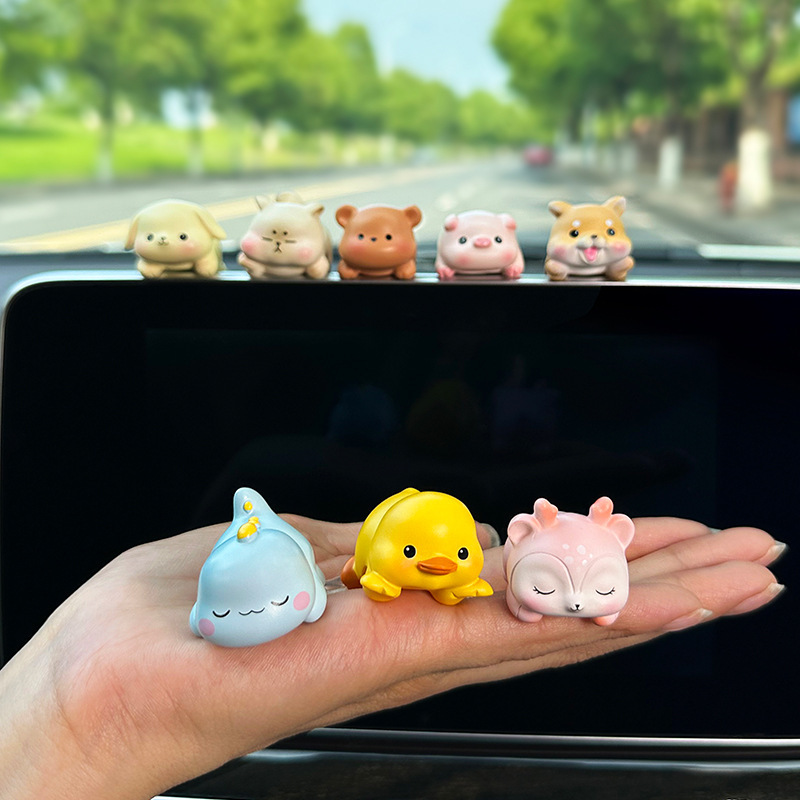 A computer decoration gift for the screen office space display in a car with a small piece of animals.