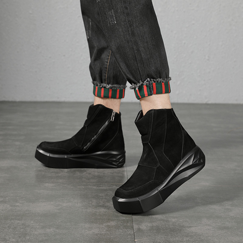 The tall man's boots are thick, dark, sand-skin Martin's boots, and he's doing it up to the gula chain boots.