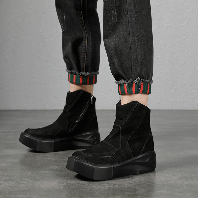 The tall man's boots are thick, dark, sand-skin Martin's boots, and he's doing it up to the gula chain boots.