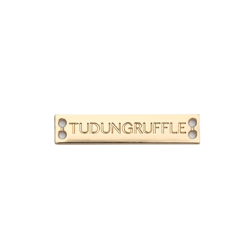 The manufacturer's metal logo dress label, the gold-plug label label, decorated as a grinding waterproof trademark.