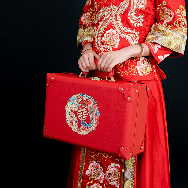 The red wedding box with the bride's suitcase.