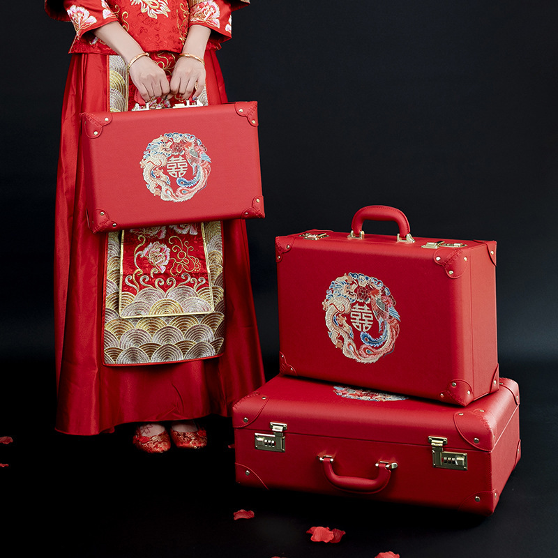 The red wedding box with the bride's suitcase.