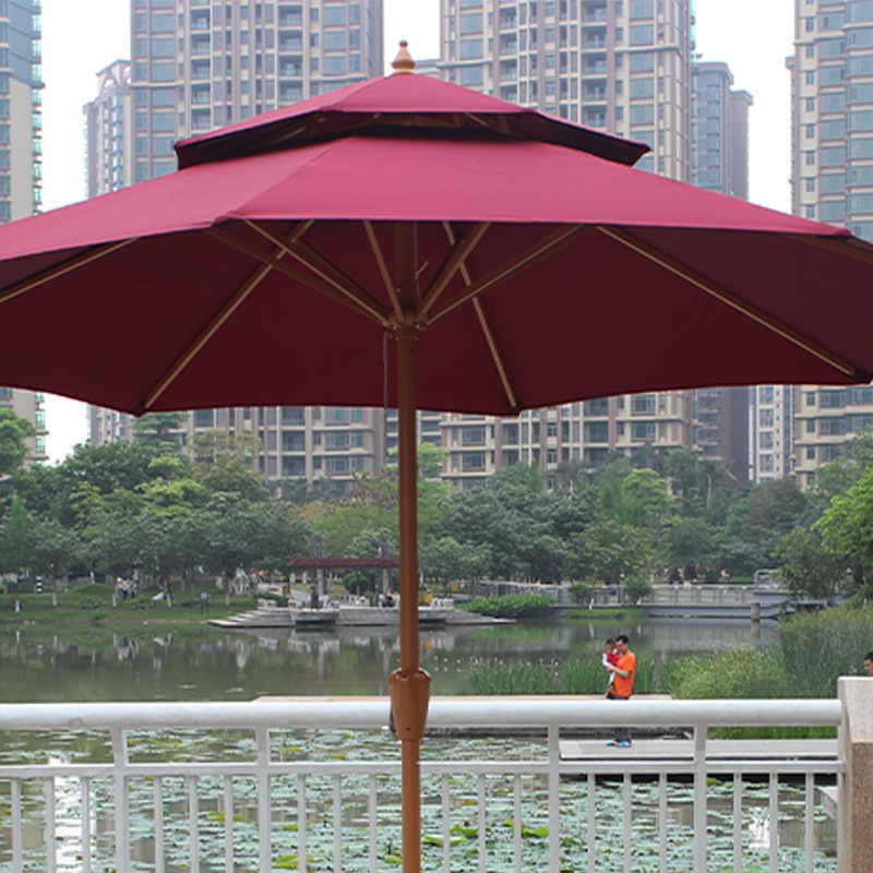 Two-caps of a wooden umbrella courtyard, thickened by an eight-bone commercial umbrella stand to block the distribution of an outdoor umbrella.