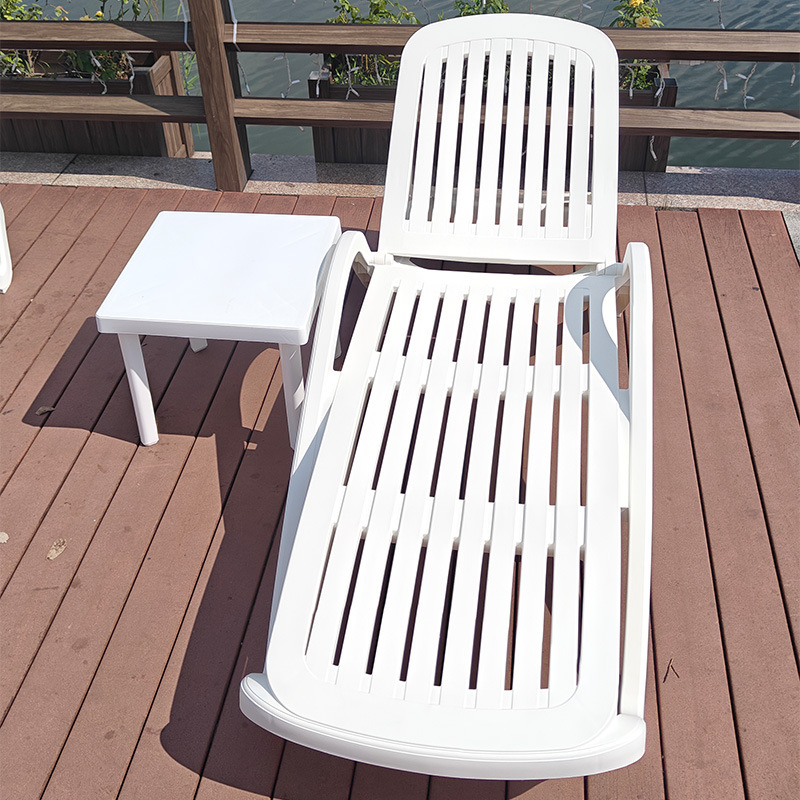 In the garden of the villa, in the pool outside, there's a plastic beach chair in the pool.