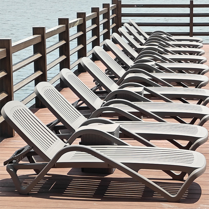 In the garden of the villa, in the pool outside, there's a plastic beach chair in the pool.