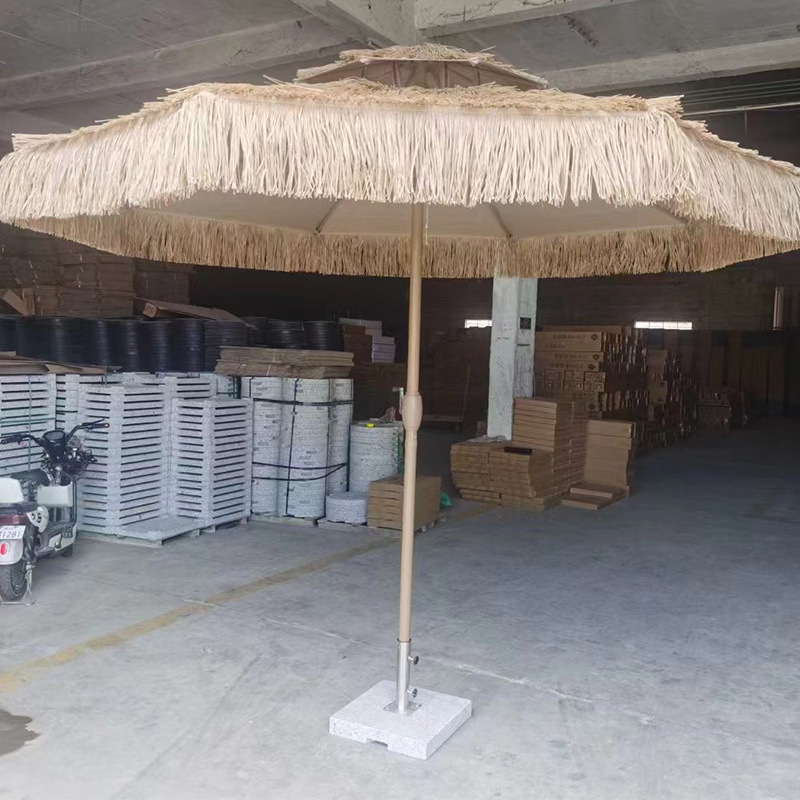 Two-top central umbrellas, round outdoors, with a large wind-shielded sun umbrella on the beachside of the courtyard.