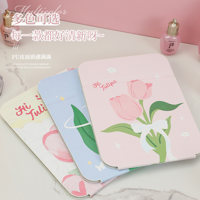 Một thư mục hoa tuy-líp nhỏ, một cô gái dựa trên môi trường với một trang điểm đẹp.