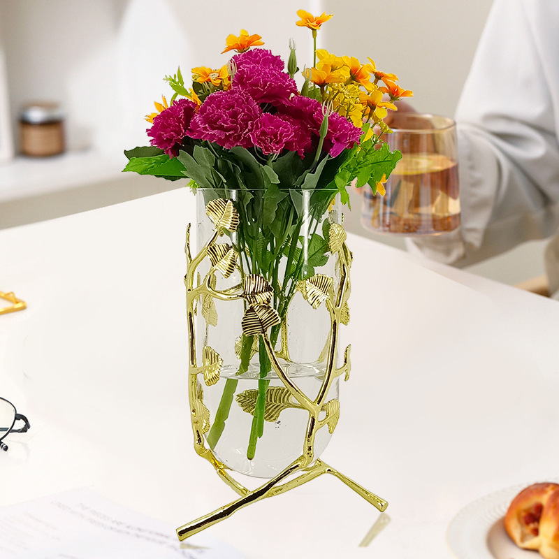 A vase set in the luxurious vase room with a bouquet of modern home-based soft decorations.