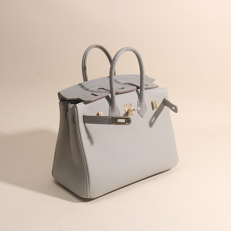 A hand-made sew-up of the porcelain guacamole touch 25cm and an imported togo wax line handbag.