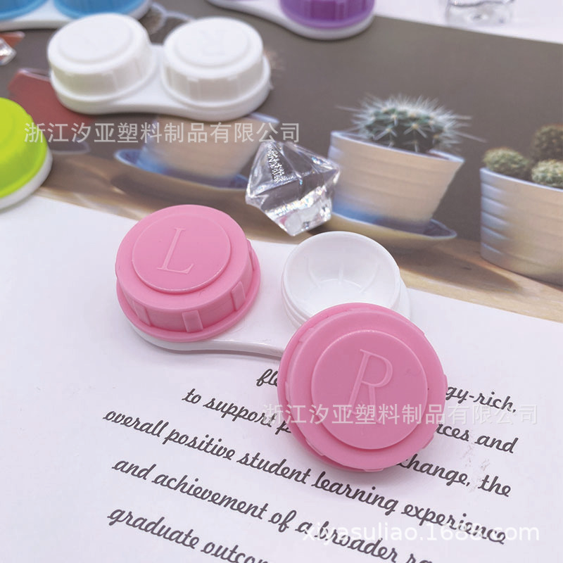 A single contact lens box with a simple pupil box with a transparent juicy pair of glasses.