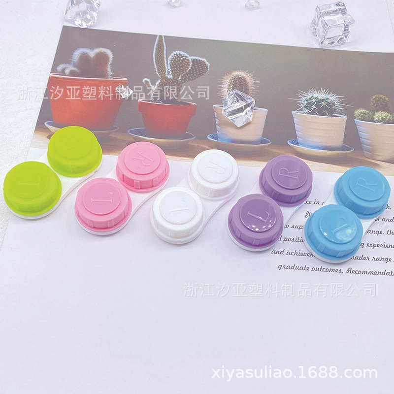 A single contact lens box with a simple pupil box with a transparent juicy pair of glasses.