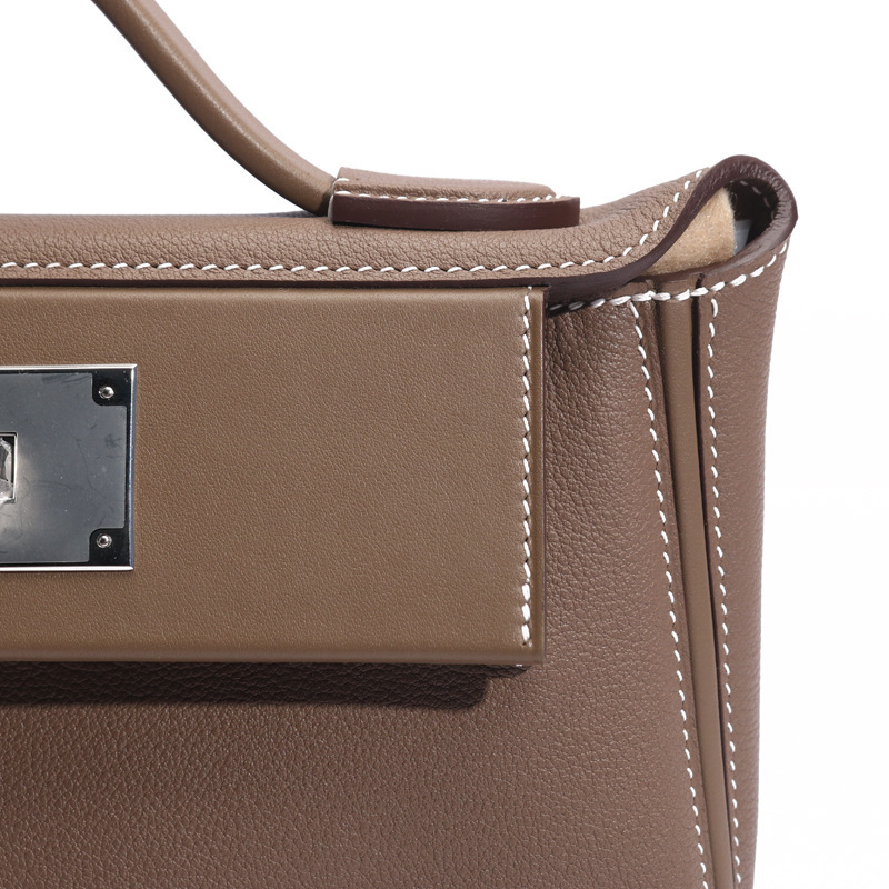 "H's original hand-sewn wax liner, Eve Swift skin, 2424 Kelly's one-shoulder-slashed leather bag."
