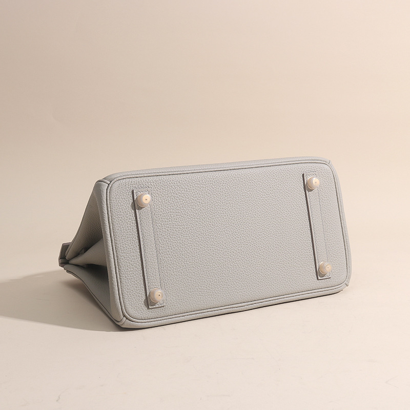 A hand-made sew-up of the porcelain guacamole touch 25cm and an imported togo wax line handbag.