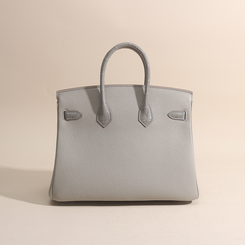 A hand-made sew-up of the porcelain guacamole touch 25cm and an imported togo wax line handbag.