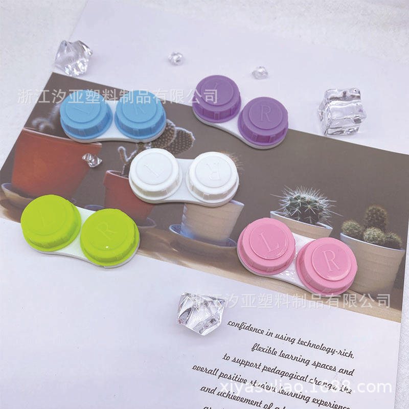 A single contact lens box with a simple pupil box with a transparent juicy pair of glasses.