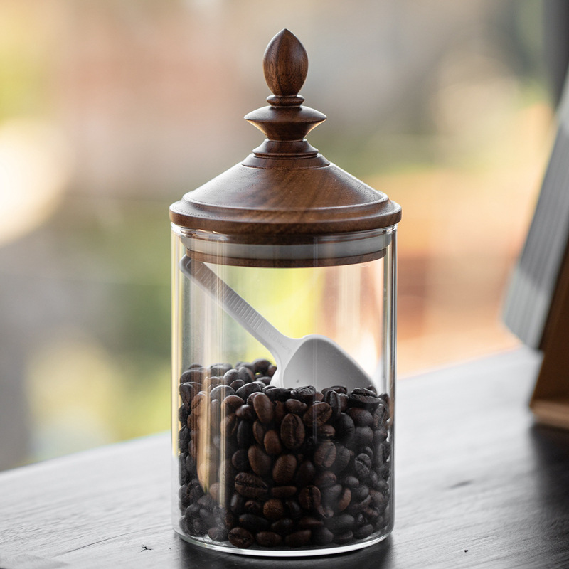 An old glass bottle of wine, a retroced coffee can, and a glass seal for tea cans.