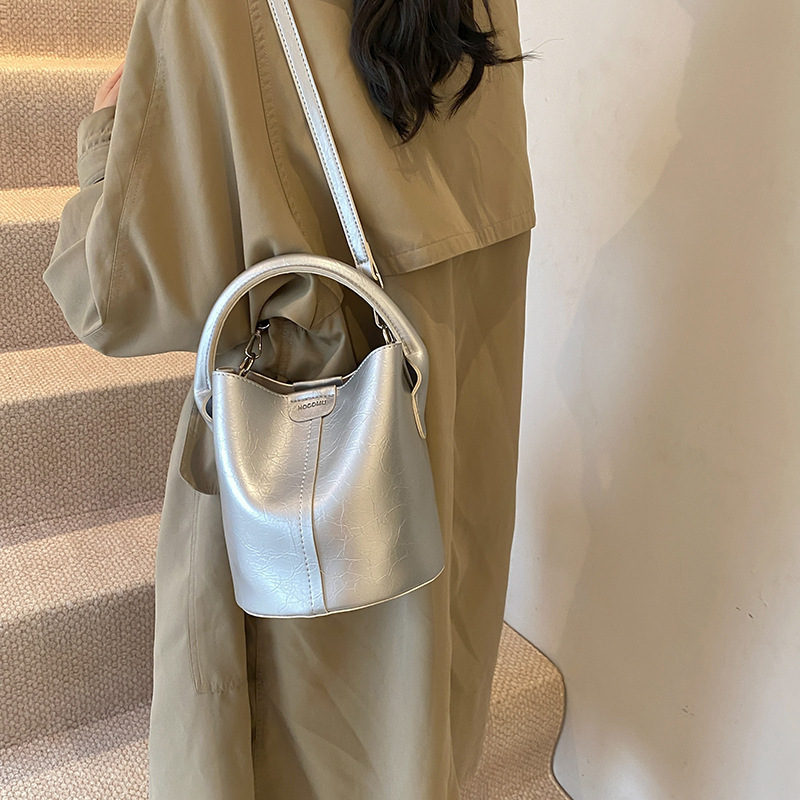 A new 2024, pure color retrofitted bucket bag, slanted.