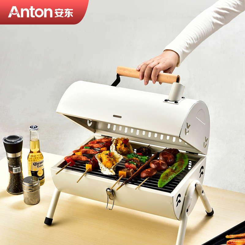 Antton barbeque camping picnic with a two-sided grill and a small, multi-purpose oven.