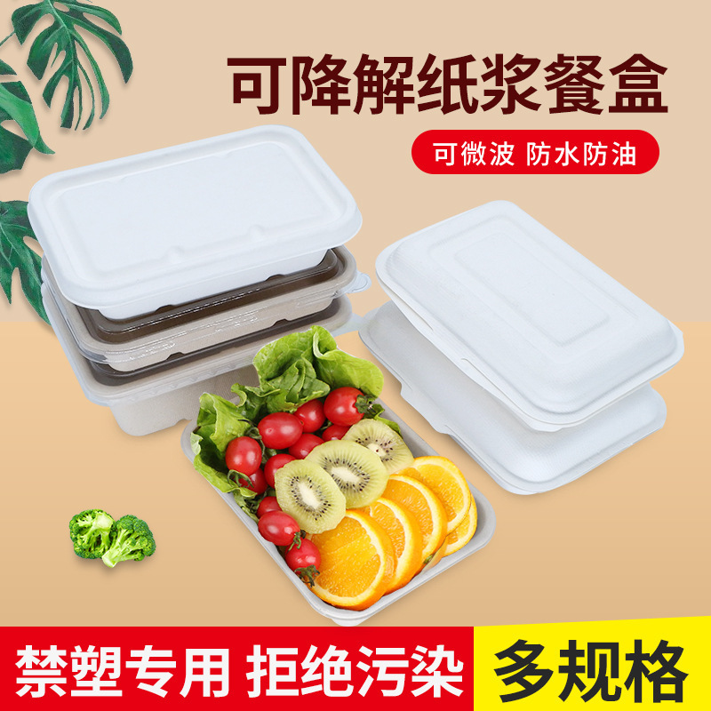 Một hộp cơm trưa có hình chữ nhật với bát mì trắng và mì ống