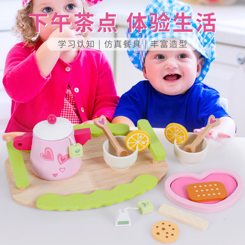 Wooded past home with a tea and dessert set to play the role of a child in the kitchen, imitating a real-life interactive toy.