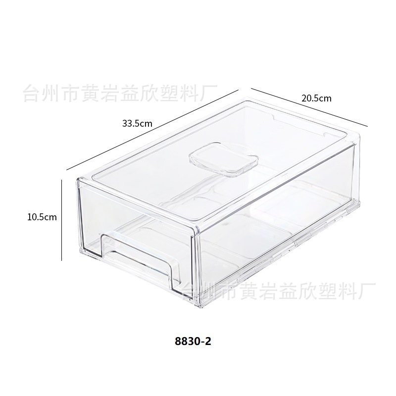 Một tủ lạnh dựa trên ngăn kéo với một tủ lạnh trái cây với một hộp đựng kẹo.