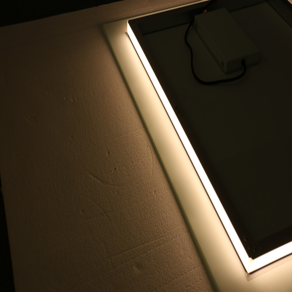 A rectangular bathroom mirror with a light wall wall and a fogproof bathroom mirror backlight