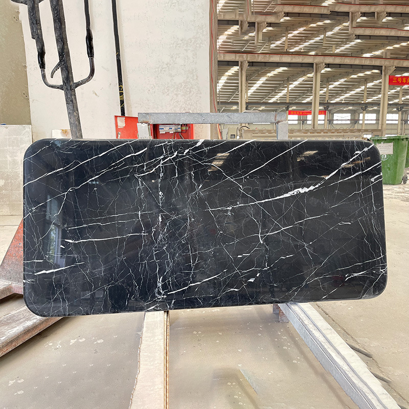 A rounded, black marble table table table table with a rounded marble mass of marble