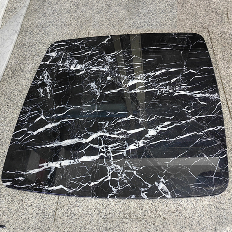 A rounded, black marble table table table table with a rounded marble mass of marble