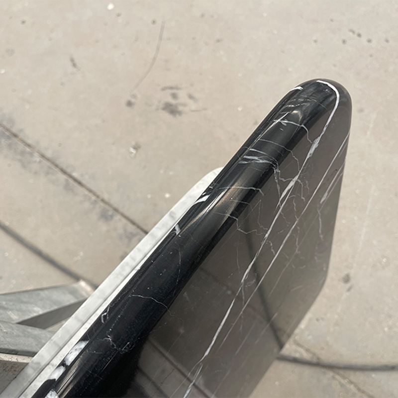 A rounded, black marble table table table table with a rounded marble mass of marble