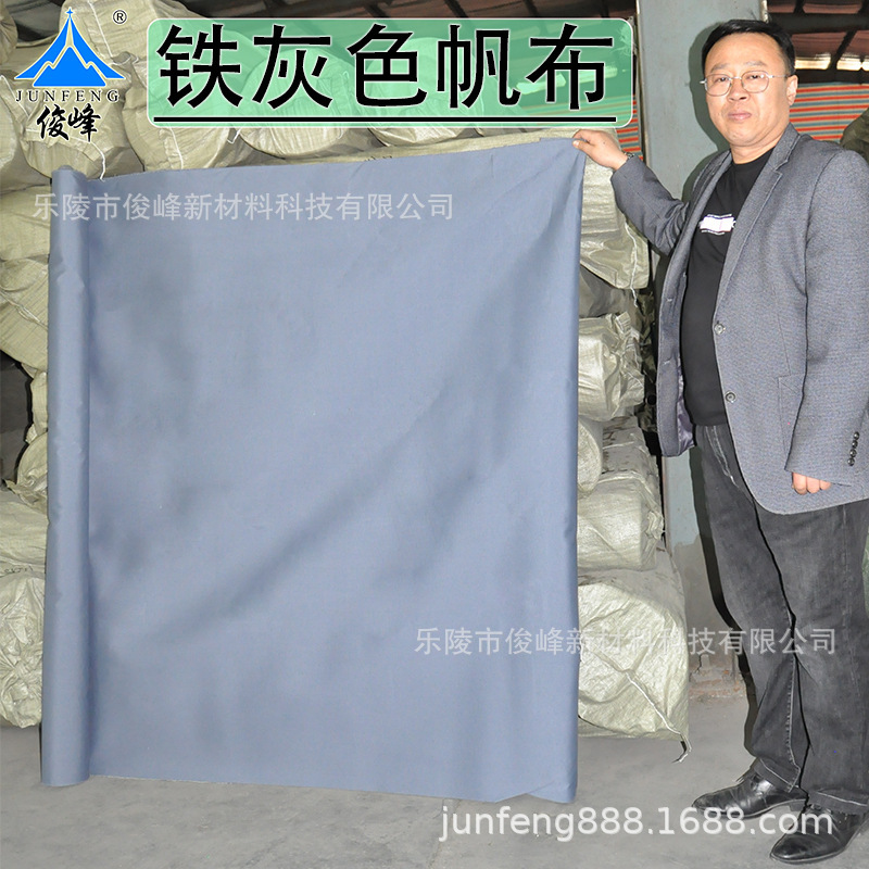 A grey canvas box with a sports mat tent covered with a dark grey and light gray tarpaulin with a canvas factory