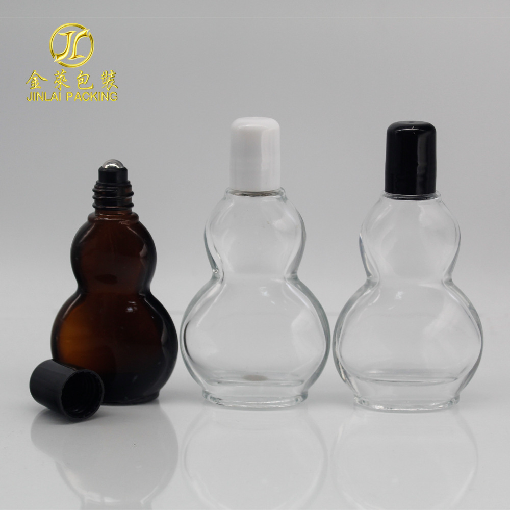 A 30-ml flat-tangled oil bottle, 50 ml brown glass spray emulsion bottle, transparent live oil roller.