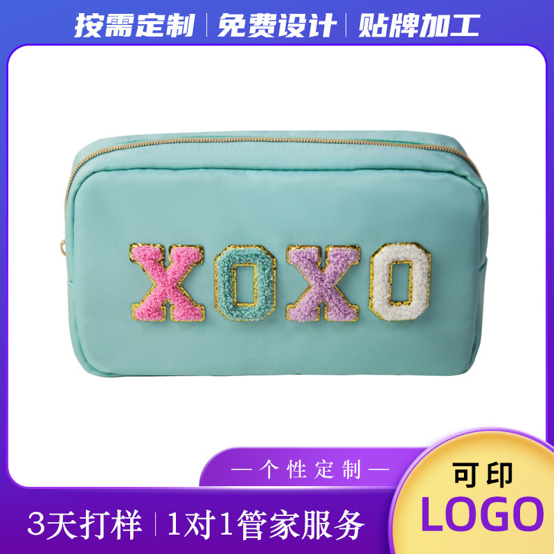 A towel embroidered and zipped with a 2022 traveler nylon make-up bag is customised with an embroidery bag.