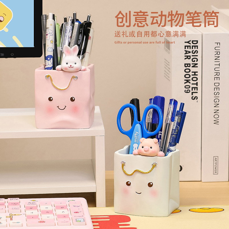 A pen full-capacity student desktop box with a girl's make-up brush at the top-cut desk.