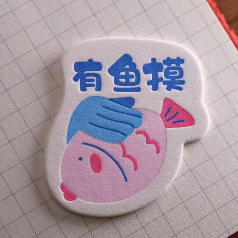 Pumpy-printed cotton-paper badges customised for an alien card idea to create a magnetic paper-suction refrigerator.