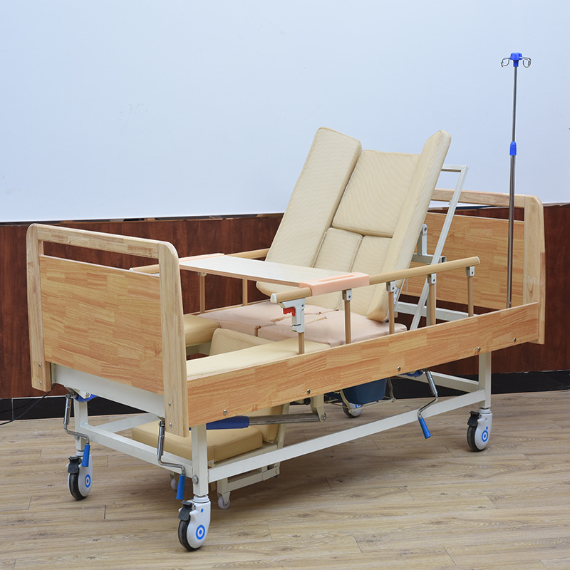 A multi-purpose nursing home bed with a side-sliding hand on the side.