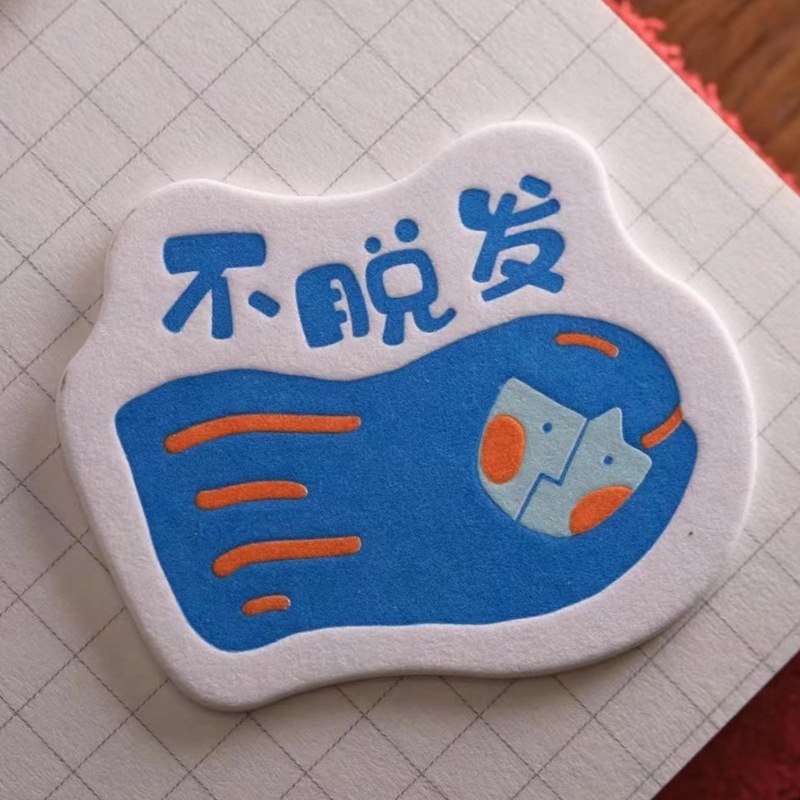 Pumpy-printed cotton-paper badges customised for an alien card idea to create a magnetic paper-suction refrigerator.