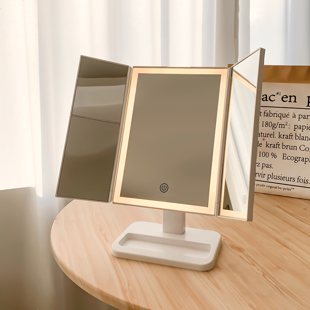 A three-faced makeup mirror with a light mirror.