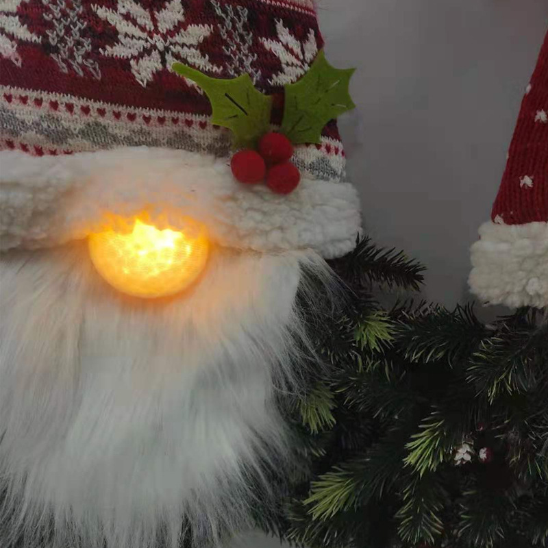 Processing custom-made Christmas decorations, a faceless old man with a lighted Christmas tree.