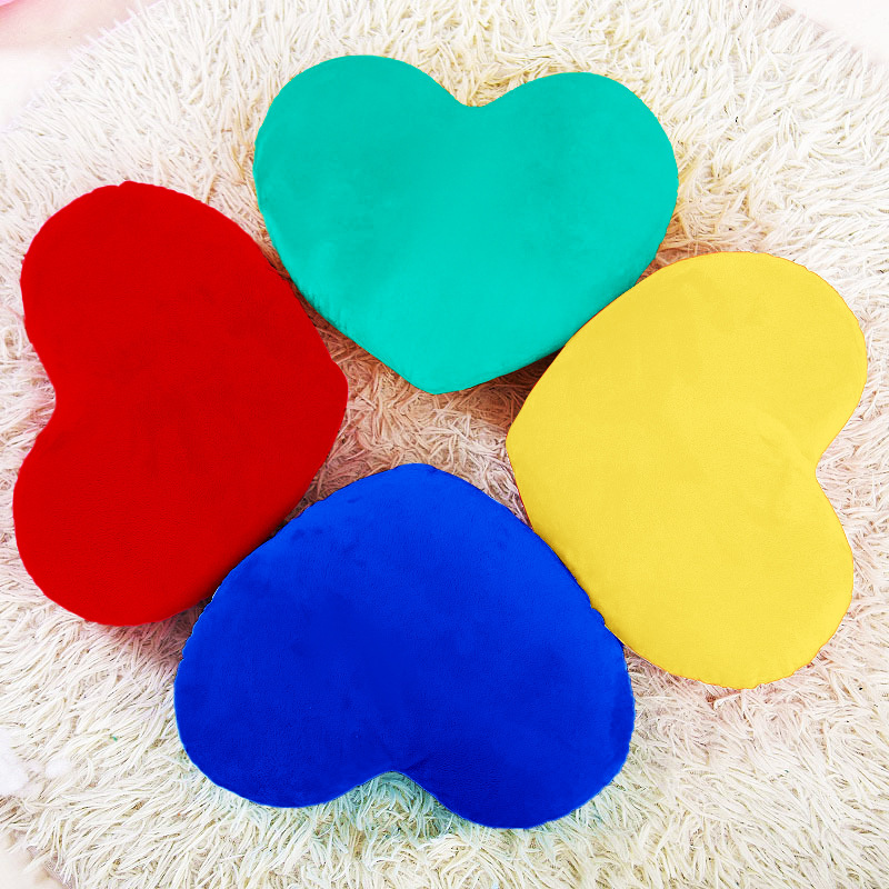 Cartoons' pillows are filled with two heart-shaped pillows.