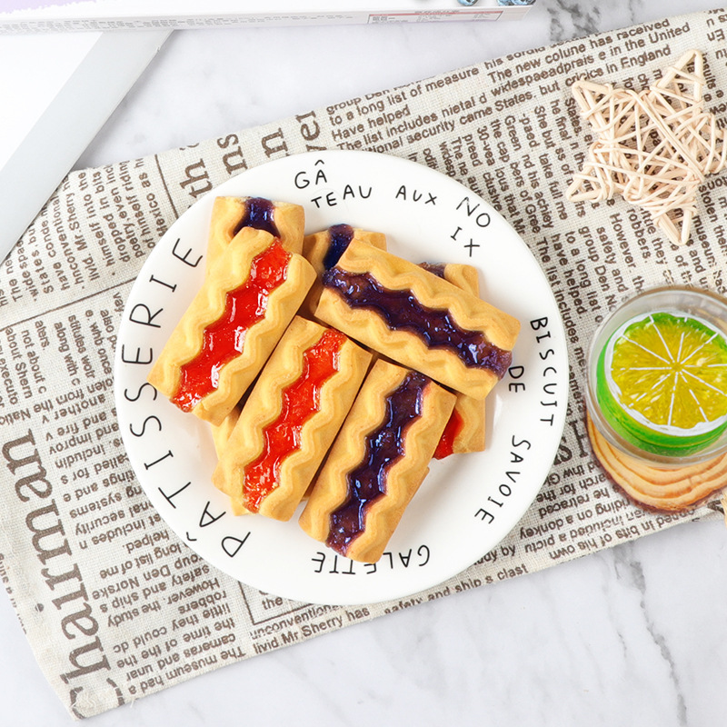 Blueberry cookies, red strawberry-fruit food, tea and jam cookies.