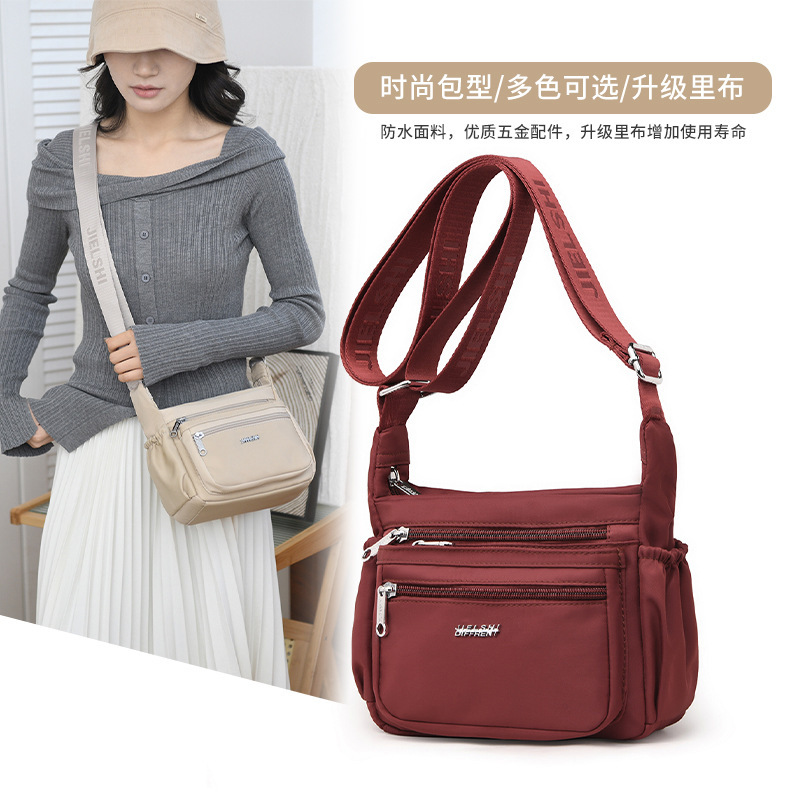 The one-shoulder-carrying, one-shoulder-free lady with a large waterproof nylon bag.