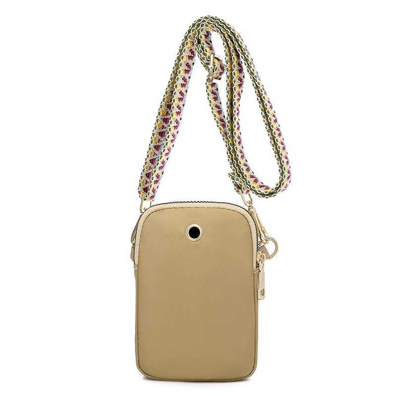 New embroidery cell phone for a lady with one-shoulder-slashed twirl bag and a waterproof nylon bag.