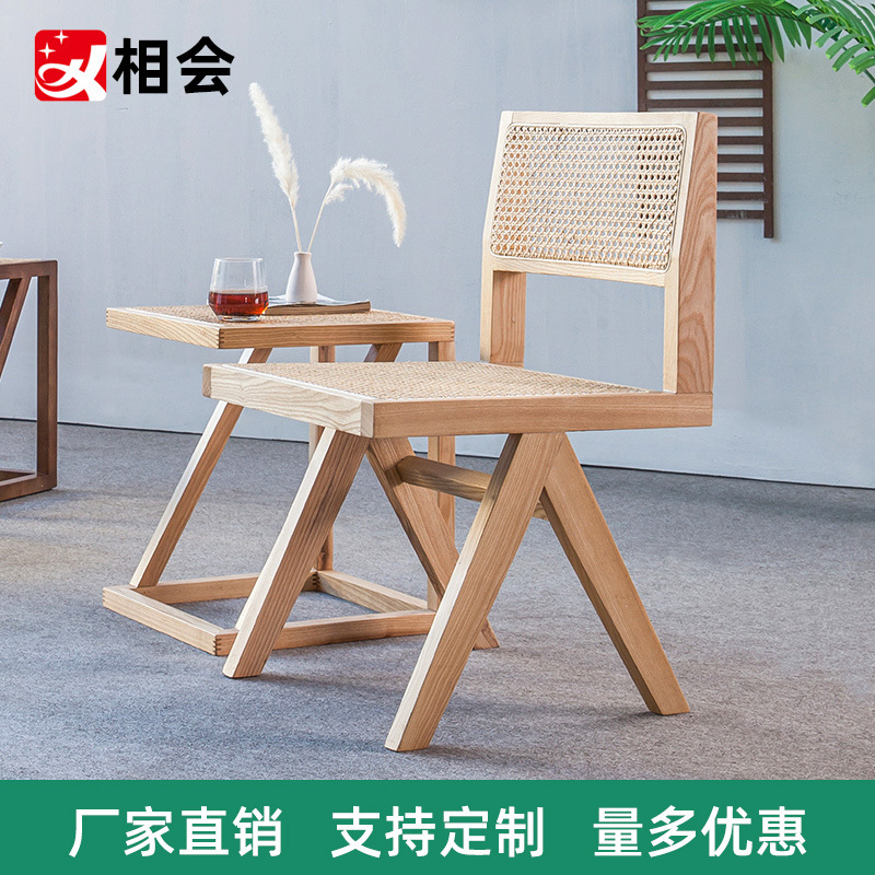 A modern, simple, white-axed wood chair with a back seat and a Nordic light luxuriant chair.