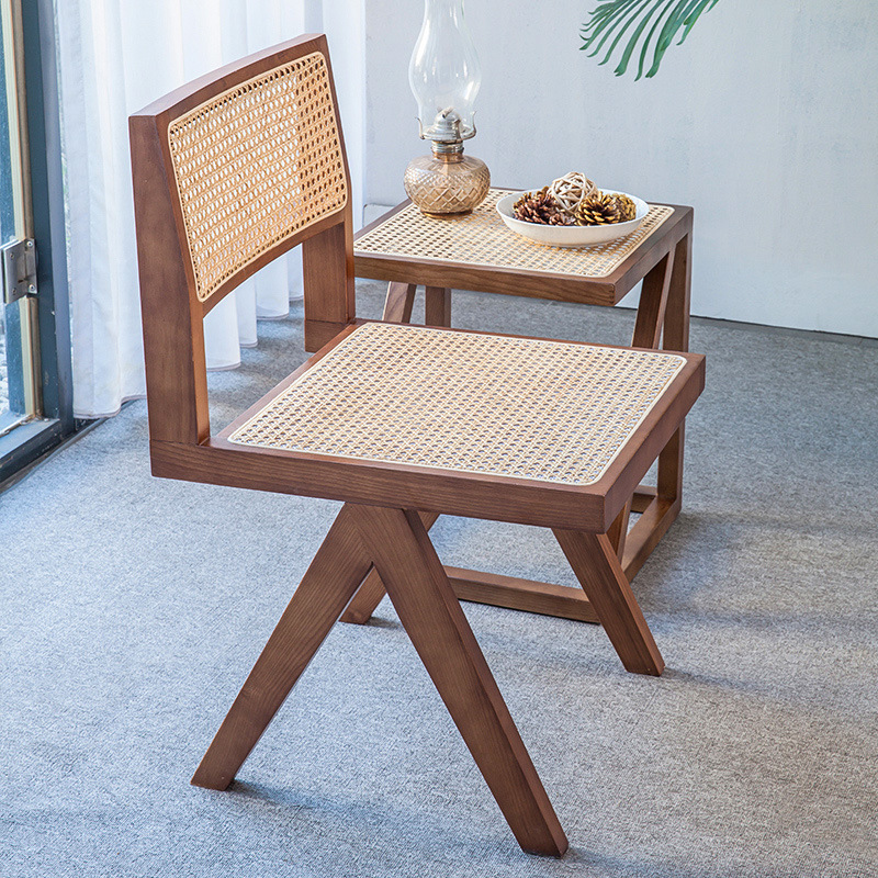 A modern, simple, white-axed wood chair with a back seat and a Nordic light luxuriant chair.