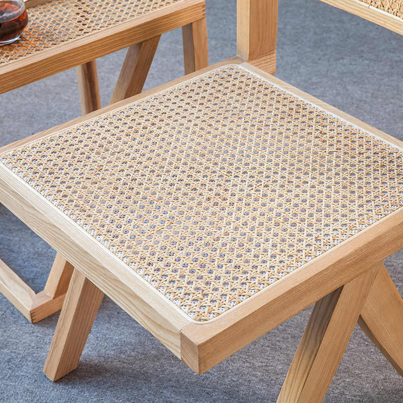 A modern, simple, white-axed wood chair with a back seat and a Nordic light luxuriant chair.