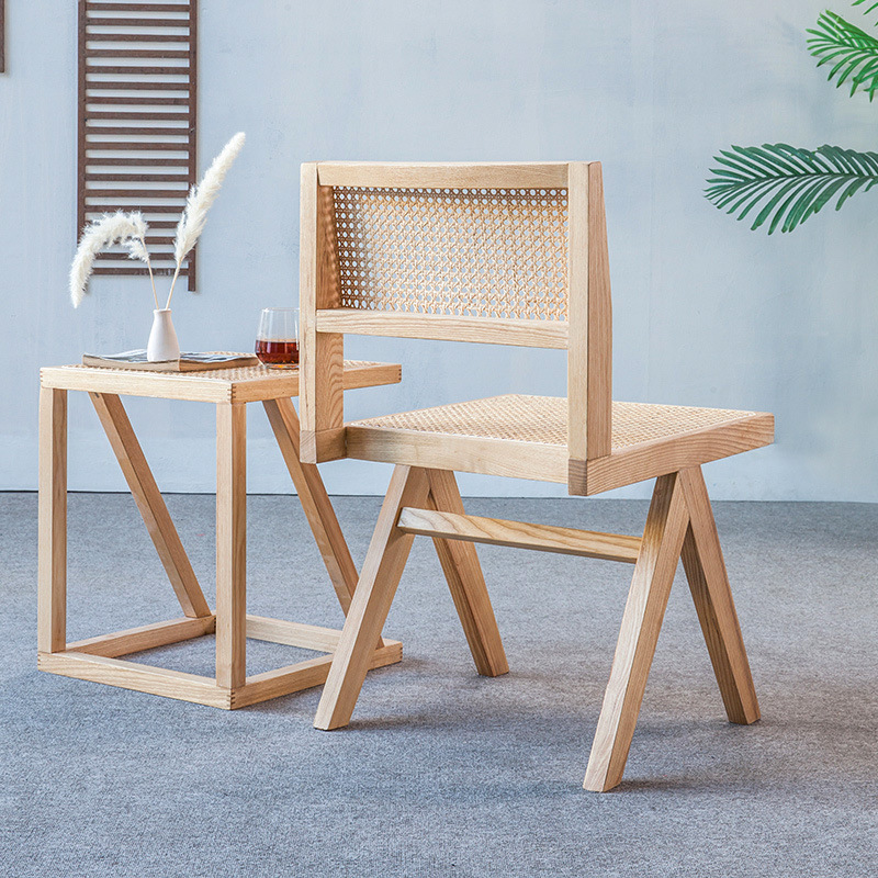 A modern, simple, white-axed wood chair with a back seat and a Nordic light luxuriant chair.