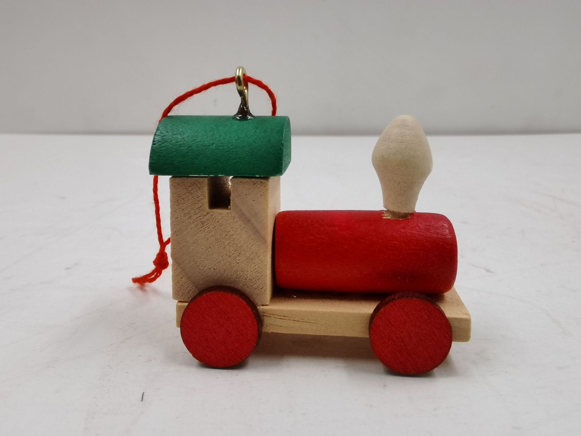 A new Christmas decoration little train holiday gift for a child on a wooden train.