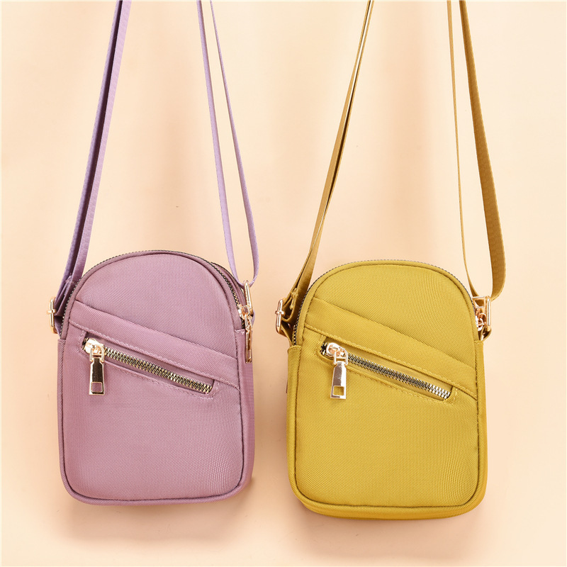 Summer nylon key cell phone bag with girl slant across the canvas.