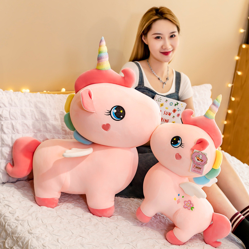 A cute unicorn birthday Christmas present for a girl with a girl with a big toy.