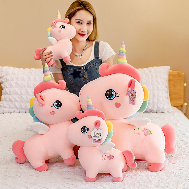 A cute unicorn birthday Christmas present for a girl with a girl with a big toy.